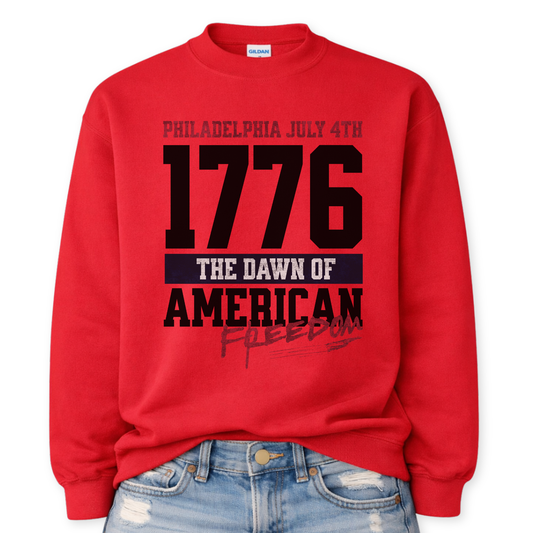 Flat-lay Gildan red crewneck sweatshirt featuring bold 1776 patriotic graphic with “Philadelphia July 4th” and “American Freedom” text.