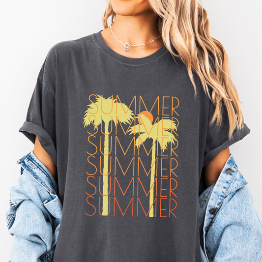 A person wearing a gray t-shirt with the text 'SUMMER' and palm trees design in orange and yellow.