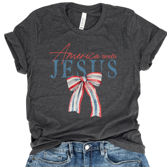 Gray t-shirt with 'America needs Jesus' graphic and blue jeans on a white background