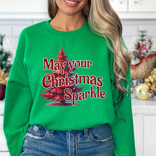 May your Christmas sparkle with fake red glitter on a red Christmas tree graphic.  woman wearing a green sweatshirt