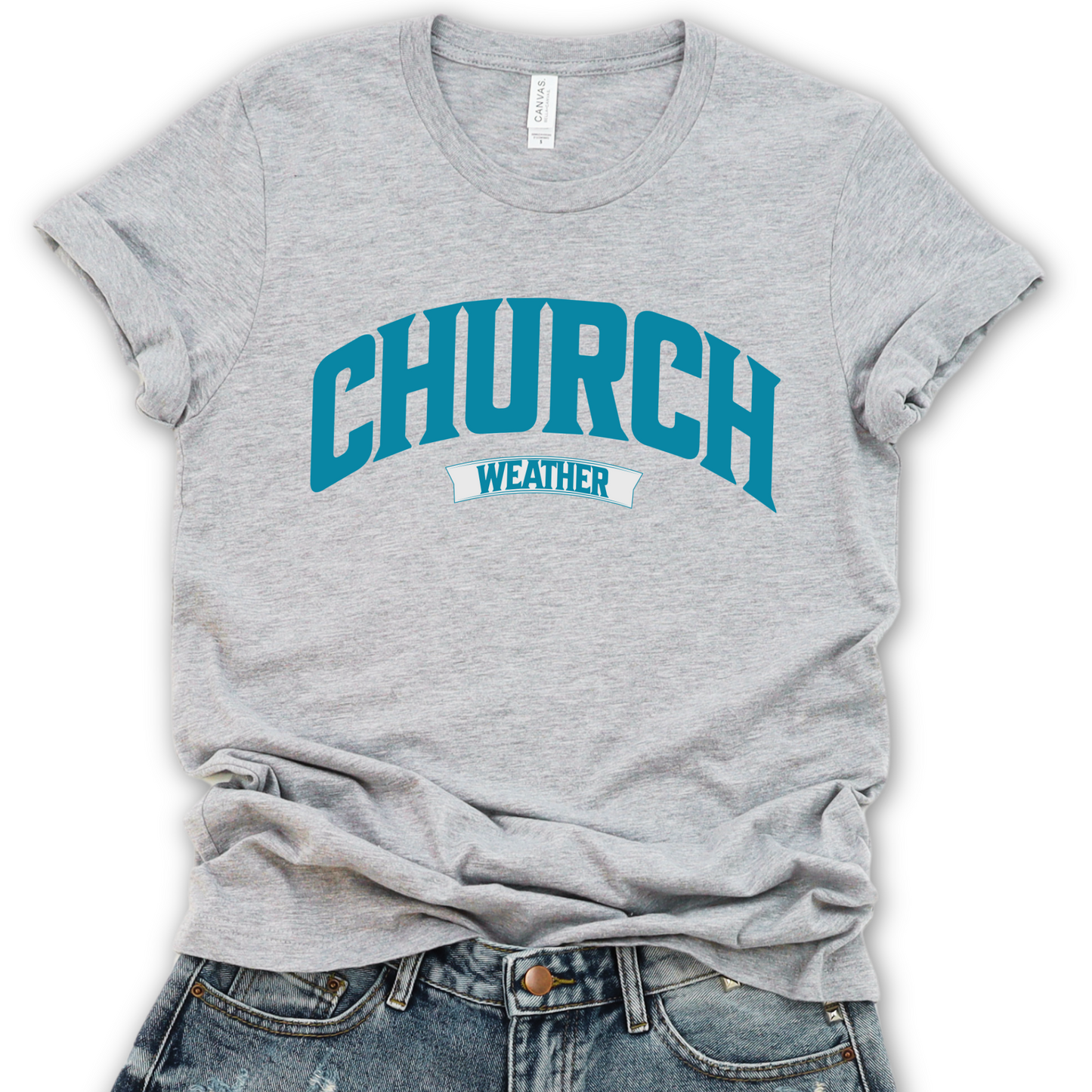 A gray unisex graphic t-shirt with the text 'CHURCH' in blue and 'weather' in a smaller font, displayed on a flat surface with casual clothing.