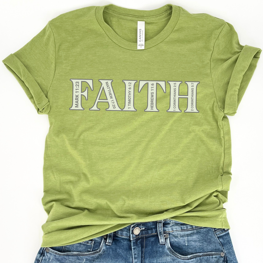 A green graphic t-shirt with the word 'FAITH' printed in white, displayed on a casual fit model with rolled sleeves.