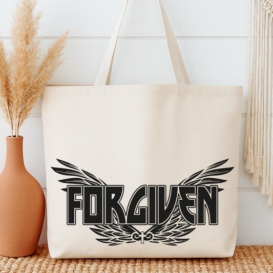Beige tote bag with 'FORGIVEN' design on a white wall background
