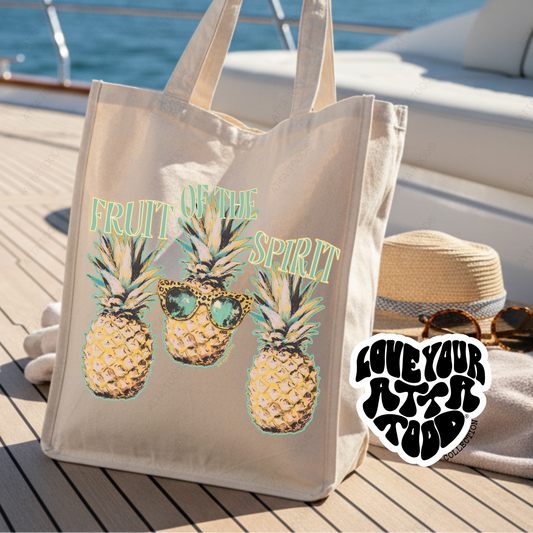 Tote bag with pineapple design and sunglasses on a boat deck. Fruit of the spirit