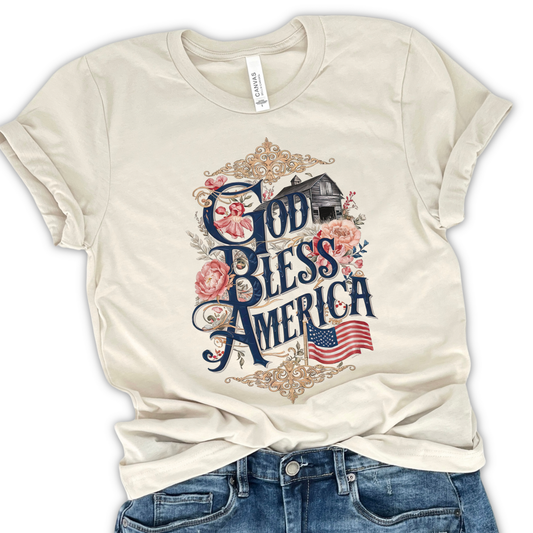 God Bless America cream color t-shirt with american flag and a gray barn