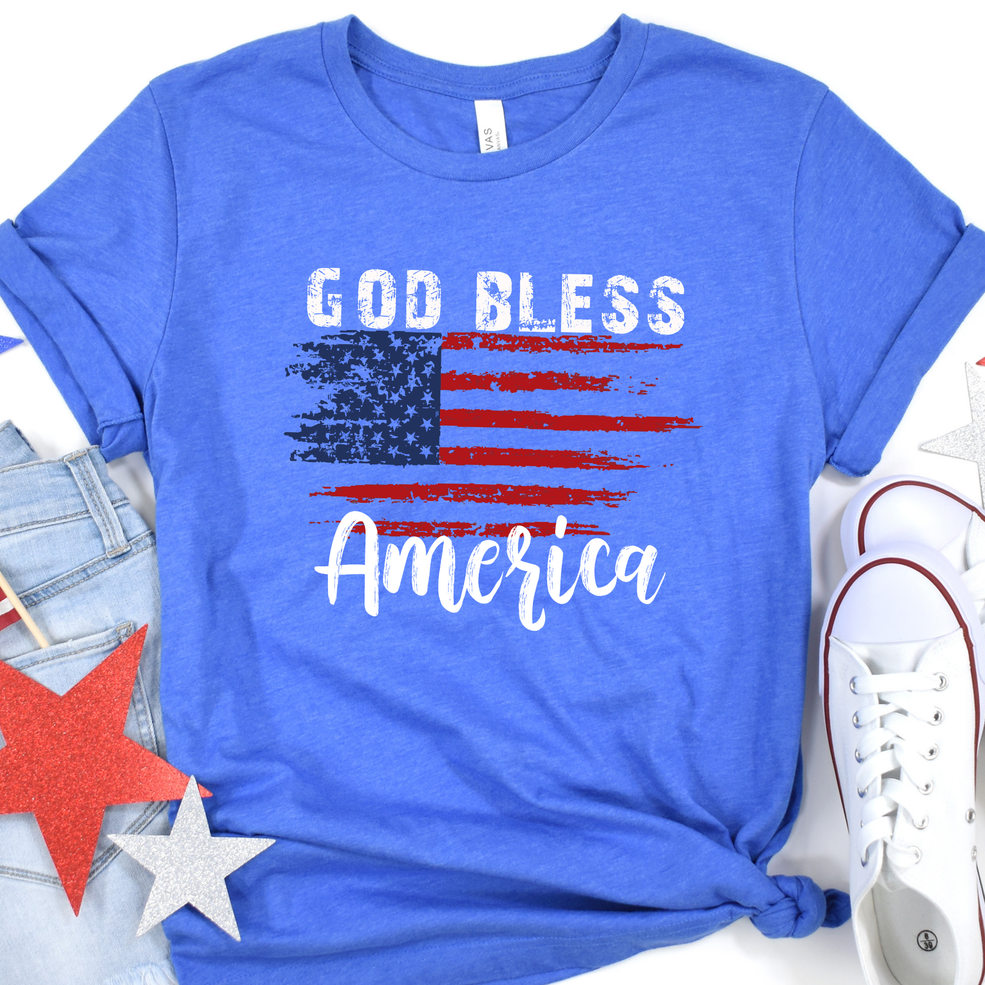 God Bless America distressed American Flag on a Heather True Royal blue t-shirt