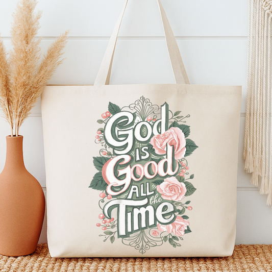 Tote bag with 'God is Good All the Time' text and floral design next to a vase and decorative items.