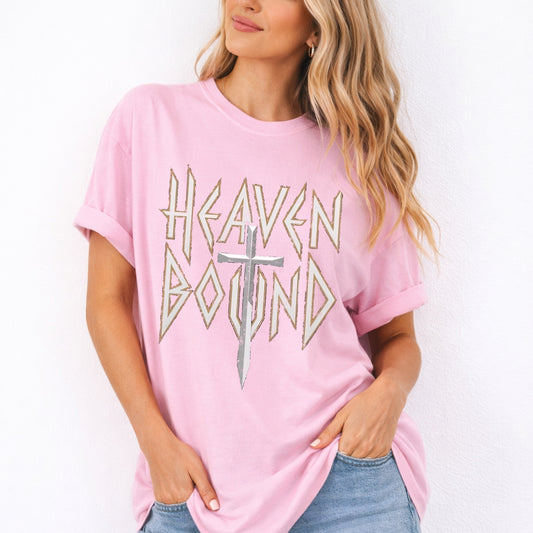 Woman wearing a pink t-shirt with 'Heaven Bound' text and cross graphic on a white background