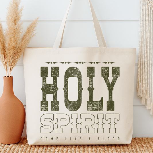 Tote bag with 'Holy Spirit' text next to a vase with dried plants on a wooden surface.