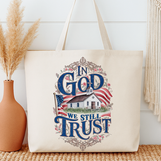Tote bag with 'In God We Still Trust' design on a neutral background