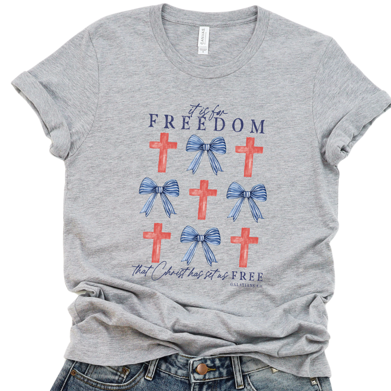 Gray t-shirt with red crosses and blue bows on a white background.  It is for Freedom that Christ has set us FREE.