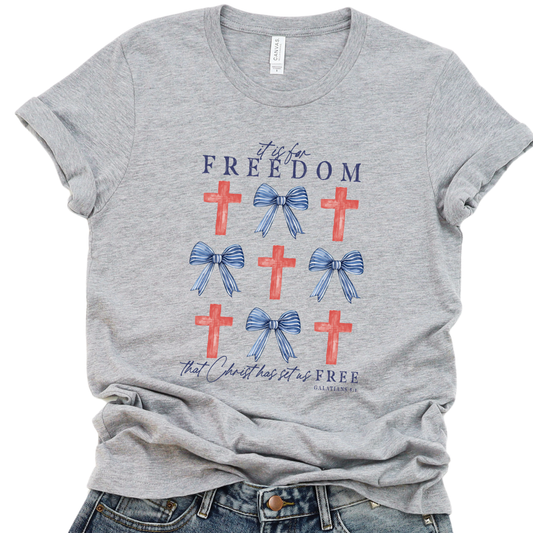 Gray t-shirt with red crosses and blue bows on a white background.  It is for Freedom that Christ has set us FREE.