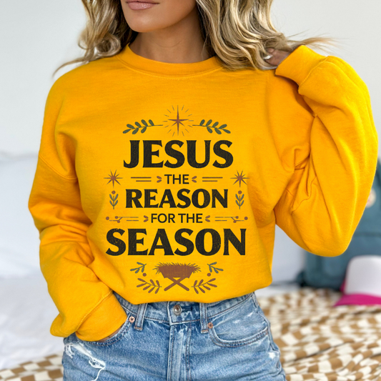 Person wearing a yellow sweatshirt with 'Jesus: The Reason for the Season' text.