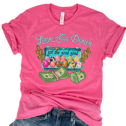 Pink t-shirt with 'Local Egg Dealer' graphic design on a white background