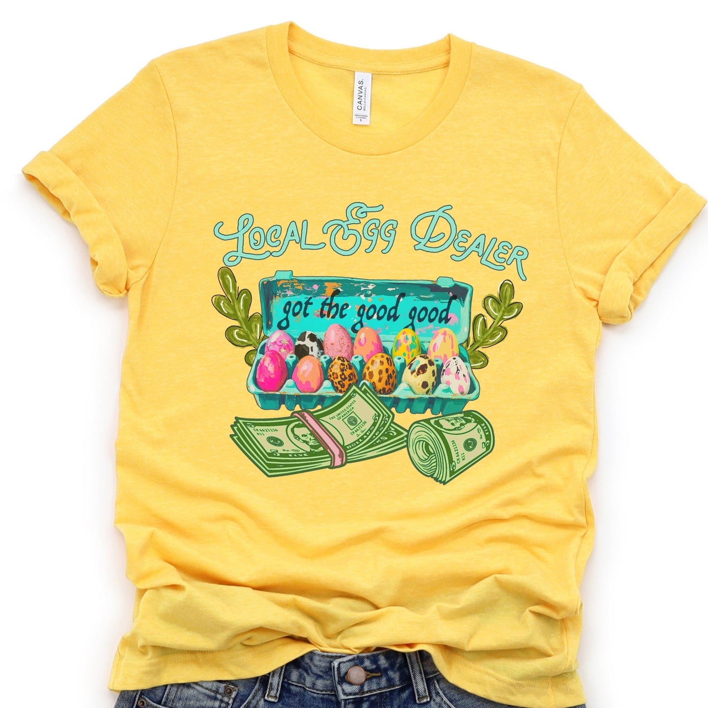 Yellow t-shirt with 'Local Egg Dealer' graphic design on a white background