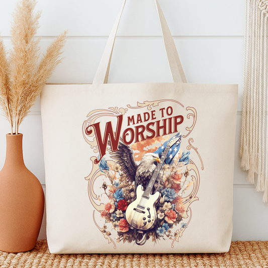 Tote bag with 'Made to Worship' design featuring an eagle, guitar, and flowers on a neutral background.