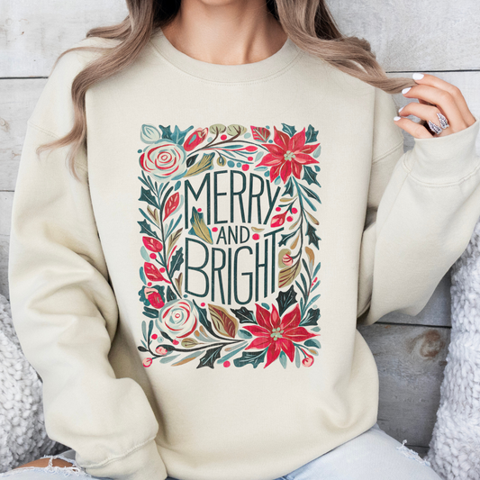 Beige sweatshirt with 'Merry and Bright' design featuring flowers and holly.