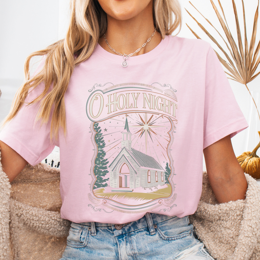 Person wearing a pink t-shirt with a church graphic and 'O Holy Night' text.  Featuring a white Church
