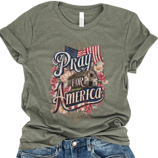 Green t-shirt with 'Pray for America' graphic design featuring an American flag and house.