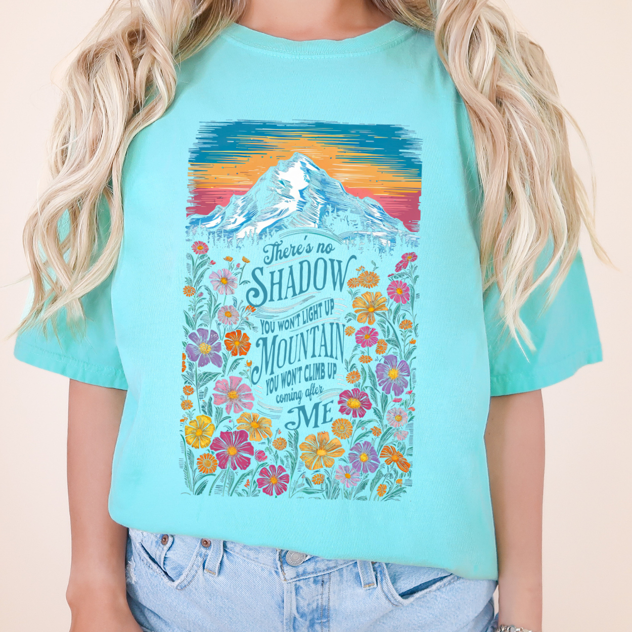 There's no shadow you won't light up and Mountain you won't climb up coming after me on a blue t-shirt with color mountain sunset
