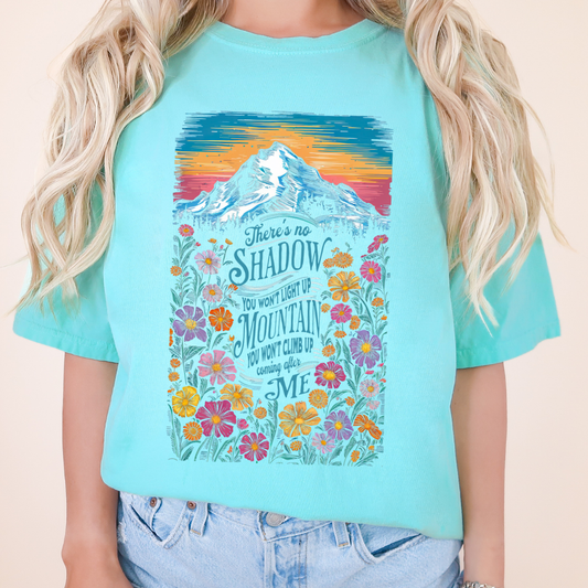 There's no shadow you won't light up and Mountain you won't climb up coming after me on a blue t-shirt with color mountain sunset