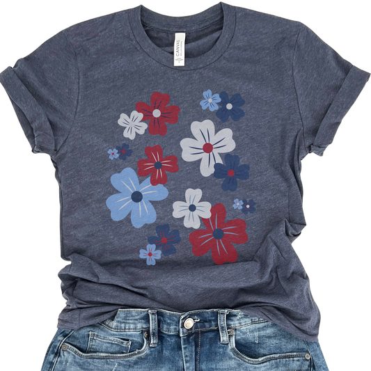 A red, white, and blue graphic t-shirt with a floral pattern, displayed on a navy background.