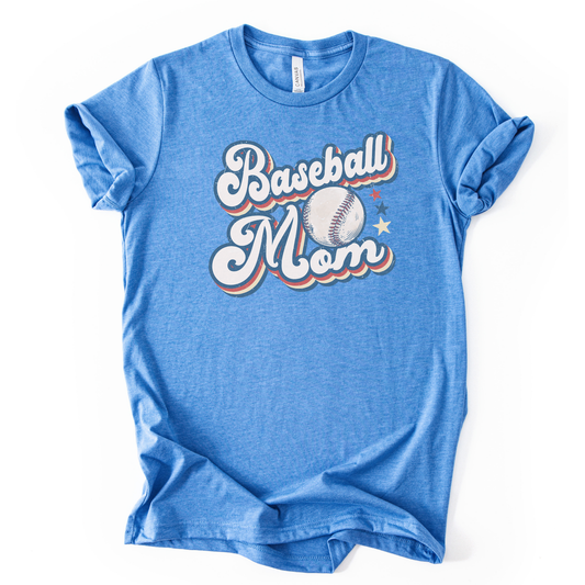 Heather columbia blue graphic t-shirt with retro-style “Baseball Mom” lettering, baseball graphic, and star accents, laid flat with rolled sleeves.