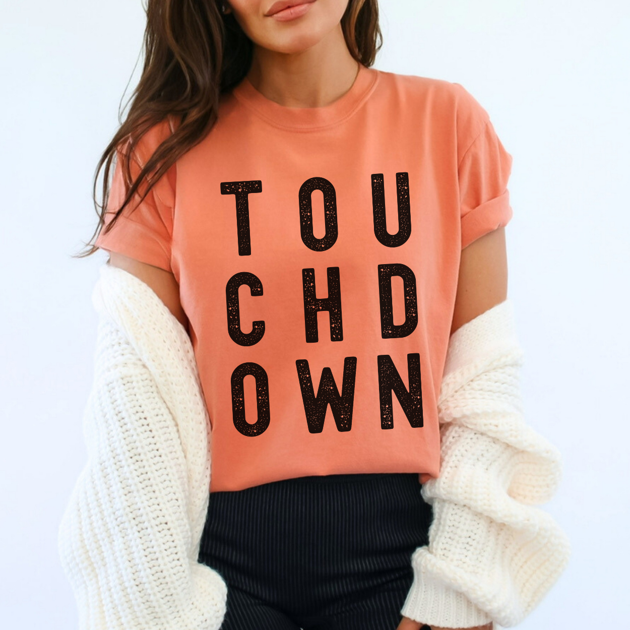 Person wearing a terracotta Comfort Colors t-shirt with 'TOUCHDOWN' text on a white background