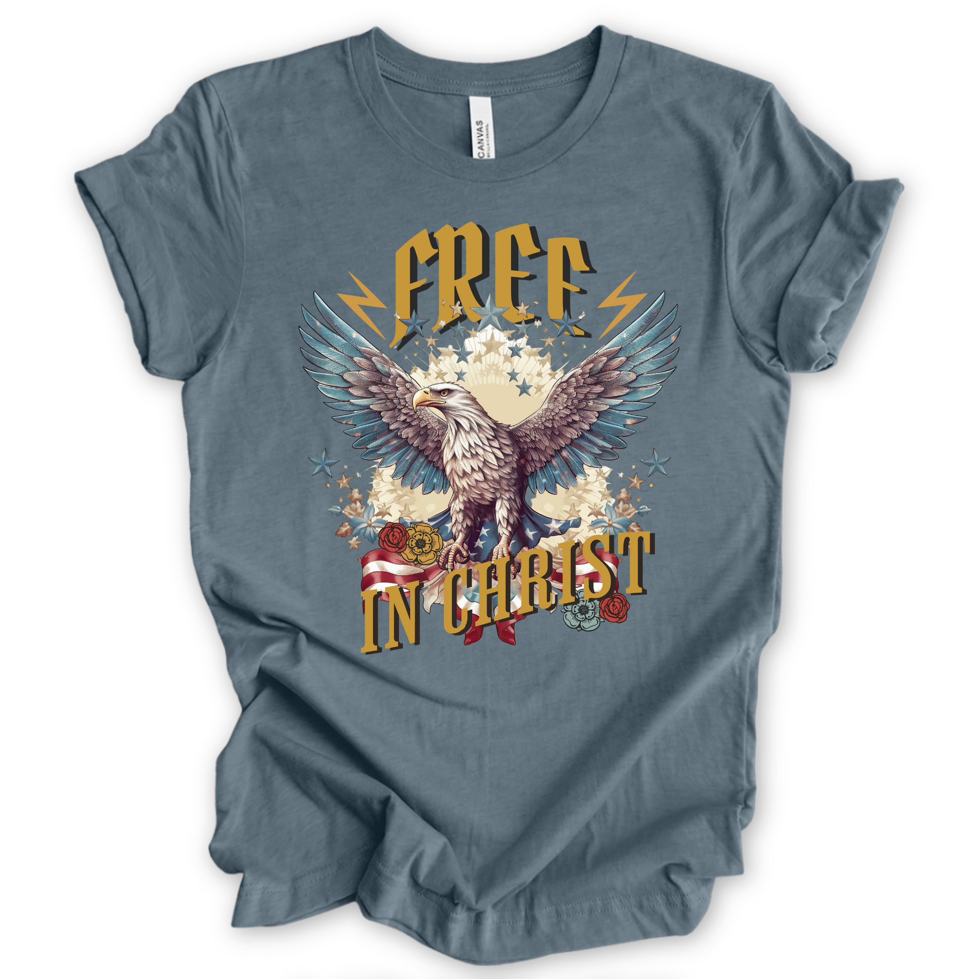Free in Christ Tee features an oversized eagle with wings spread, American flag, lighting bolts and stars.  On a Heather storm color tshirt