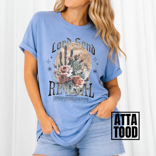 Woman wearing a blue t-shirt with a graphic design and text, standing against a white background. Lord Send revival featuring blooming cactuses