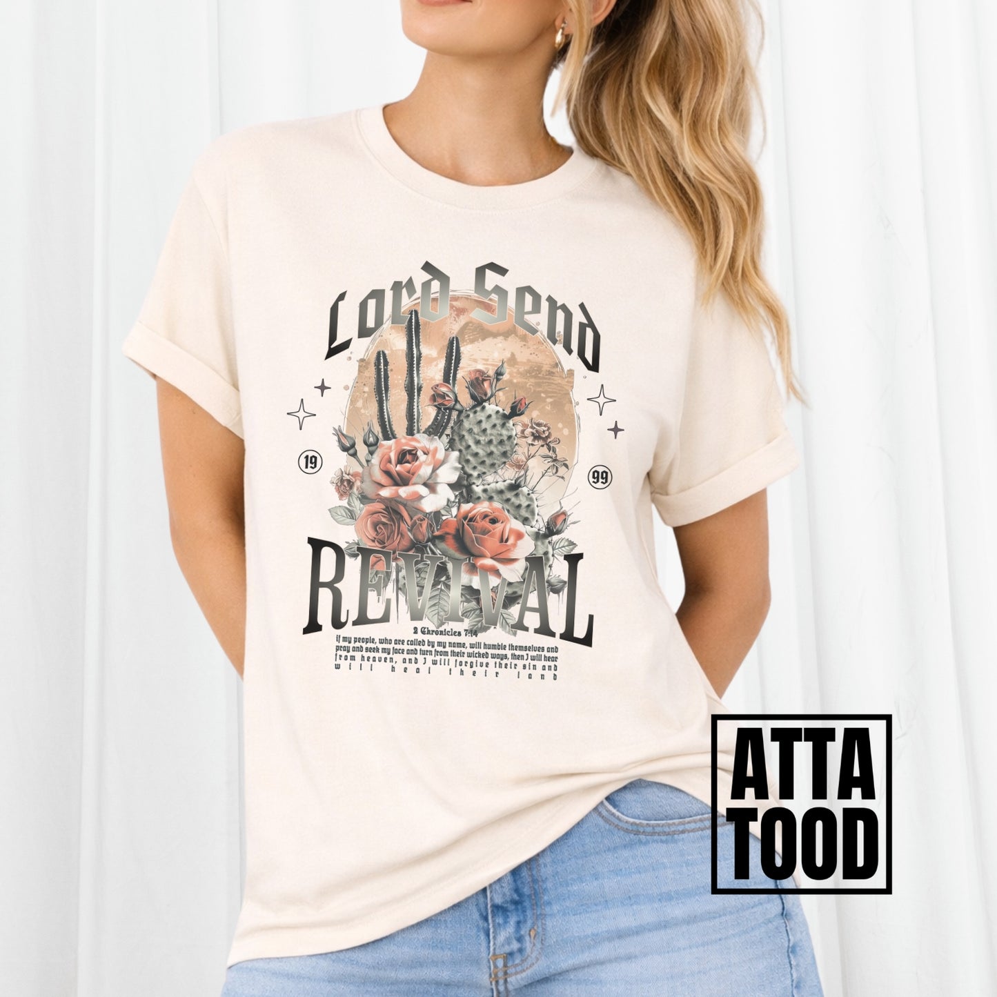Woman wearing a ivory t-shirt with a graphic design and text, standing against a white background. Lord Send revival featuring blooming cactuses