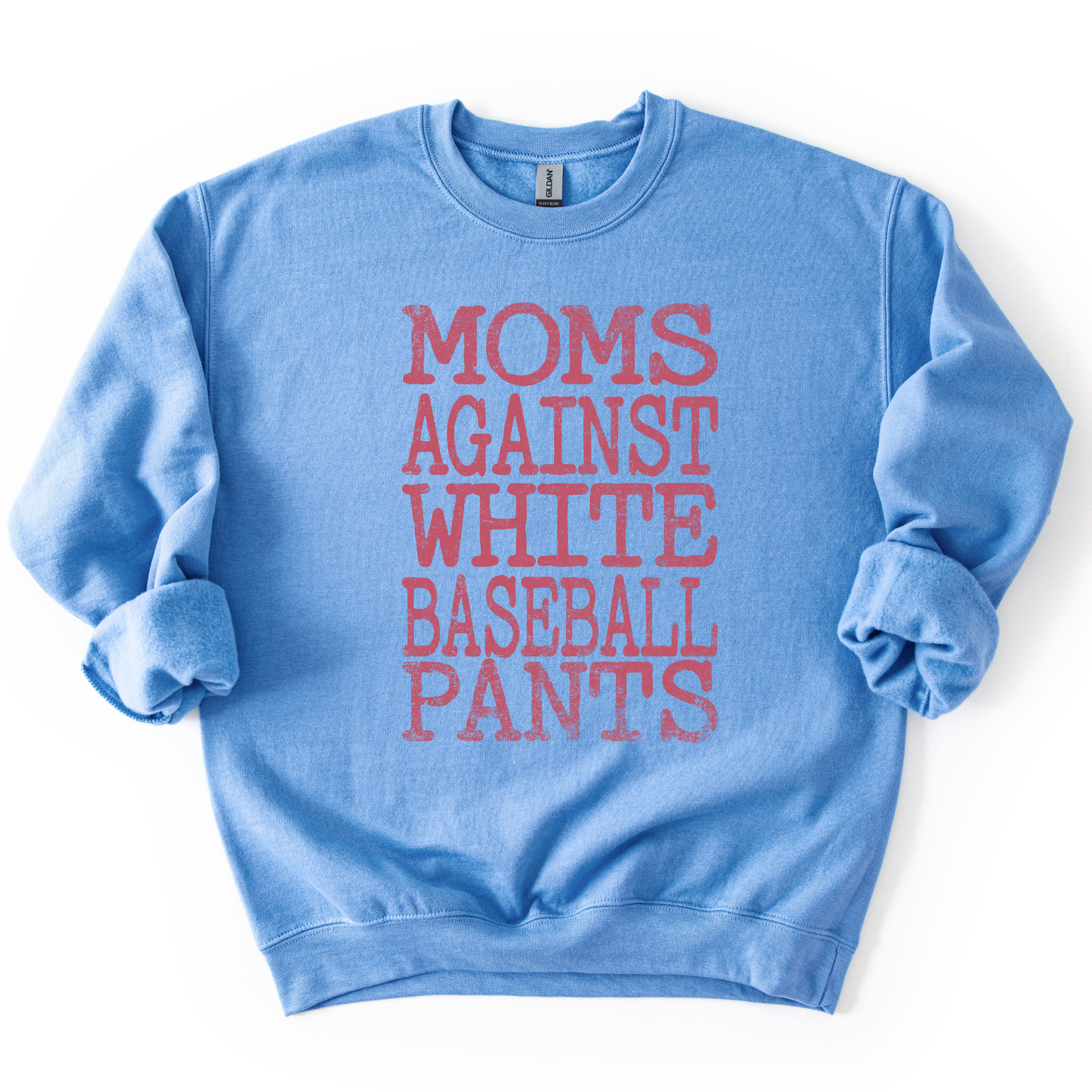 blue crewneck sweatshirt with distressed white block lettering reading “Moms Against White Baseball Pants,” styled flat with sleeves scrunched