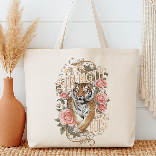 Tote bag with a tiger design and floral elements on a neutral background.  Tote says Not my Strength but His