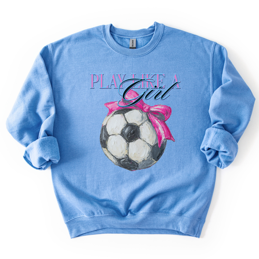 Blue sweatshirt with soccer ball and pink bow graphic and 'Play Like a Girl' text on a white background