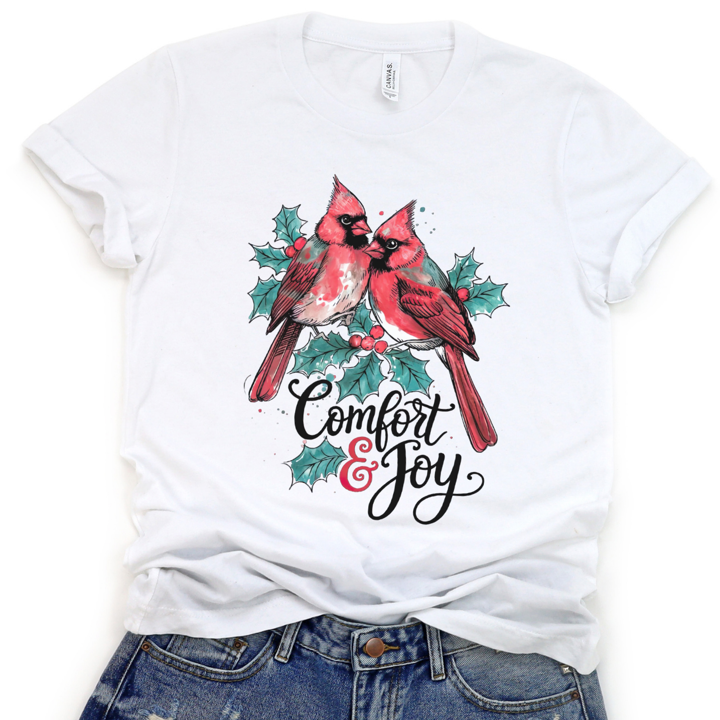 White t-shirt with red cardinals and 'Comfort & Joy' text on a white background