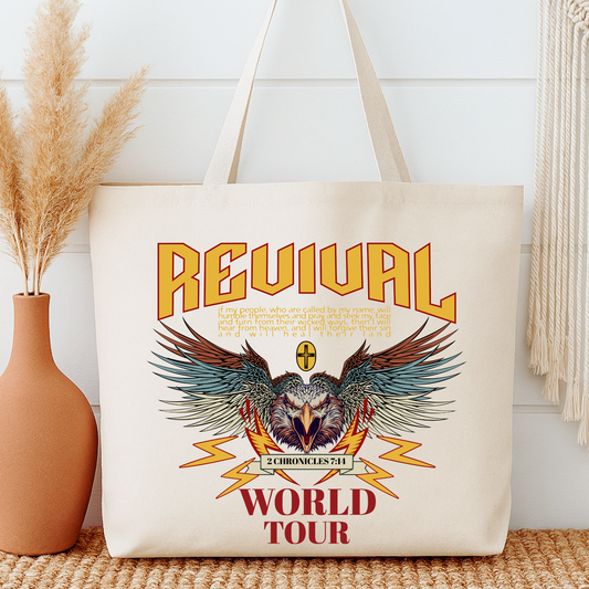 Tote bag with 'Revival World Tour' design featuring an Eagle and text, placed on a surface with decorative elements.