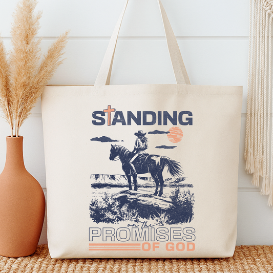 Tote bag with a graphic of a person on a horse and text 'Standing on the Promises of God' next to a vase with dried plants.