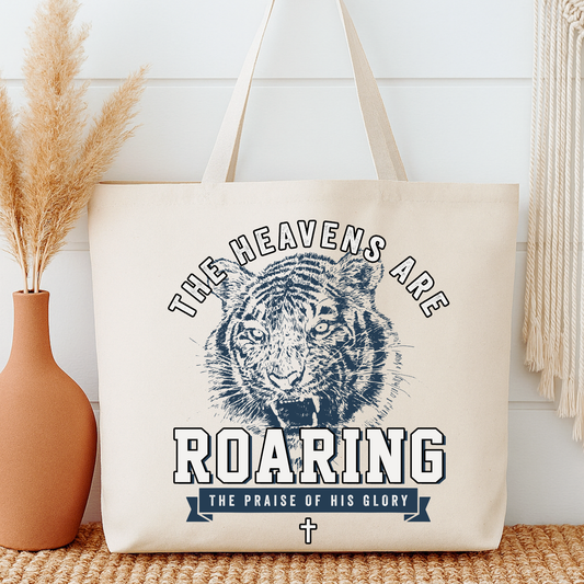 Tote bag with a blue tiger that says The heavens are roaring and The praise of His glory.