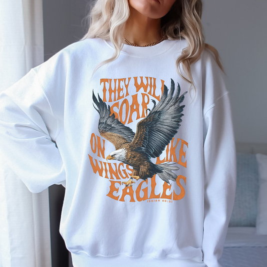 White sweatshirt with eagle graphic and text worn by a person indoors.  They will soar on like wings of an Eagles Isaiah 40:31