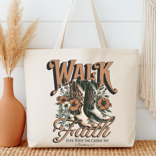 Tote bag with 'Walk by Faith' design featuring boots and flowers, placed on a surface with decorative elements.