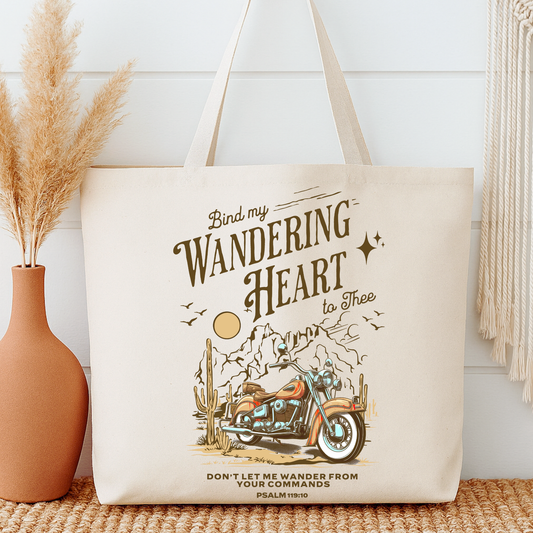 Tote bag with motorcycle design and text next to a vase on a wooden surface.  tote bag says bind my wandering heart to thee Psalm 119:10