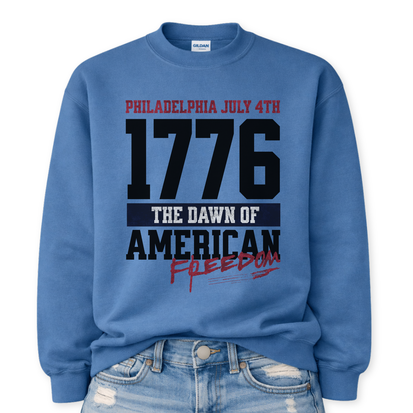 Flat-lay Gildan Indigo Blue crewneck sweatshirt featuring bold 1776 patriotic graphic with “Philadelphia July 4th” and “American Freedom” text.