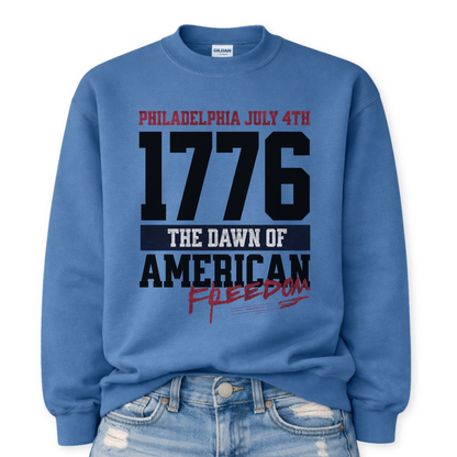 Flat-lay Gildan Indigo Blue crewneck sweatshirt featuring bold 1776 patriotic graphic with “Philadelphia July 4th” and “American Freedom” text.