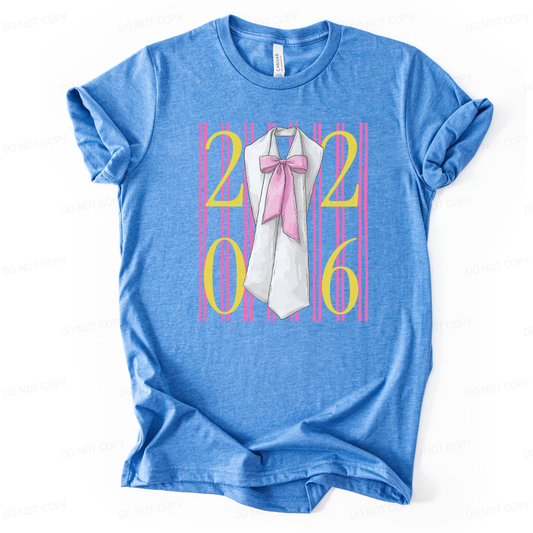 Graduation 2026 preppy themed graphic t shirt. The design features bold 2026 lettering layered over vertical pink stripes, centered with a graduation sash illustration accented by a soft pink bow. The bright color contrast and feminine detailing create a standout senior year statement with clear Class of 2026 visibility and trend driven appeal.
