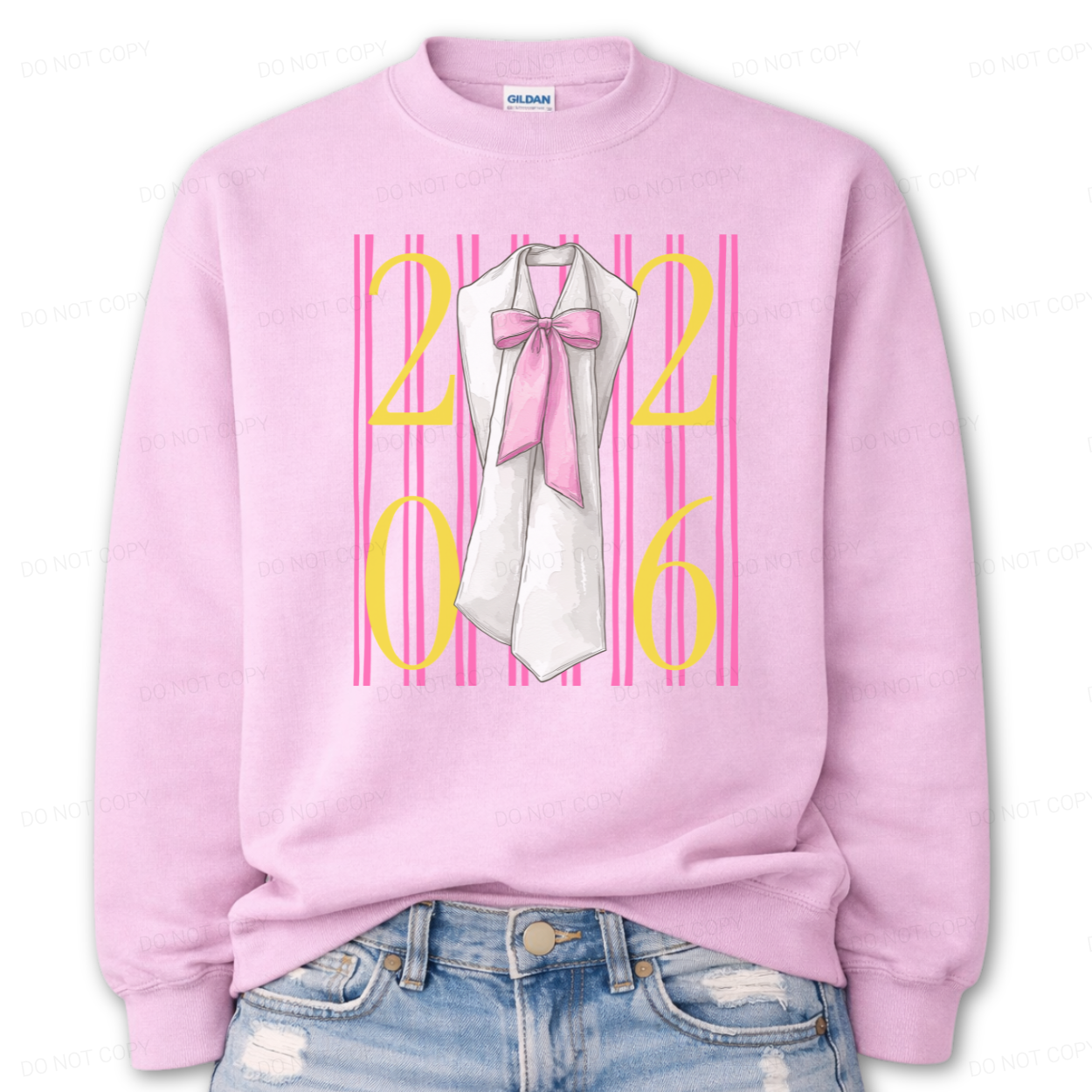 Graduation 2026 graphic on a classic pink crewneck sweatshirt. The design features bold 2026 numerals layered over vertical pink stripe accents, centered with a detailed sash illustration finished with an oversized pink bow. The feminine bow detail combined with strong year callout creates a standout Class of 2026 statement that works for both high school seniors and college graduates.