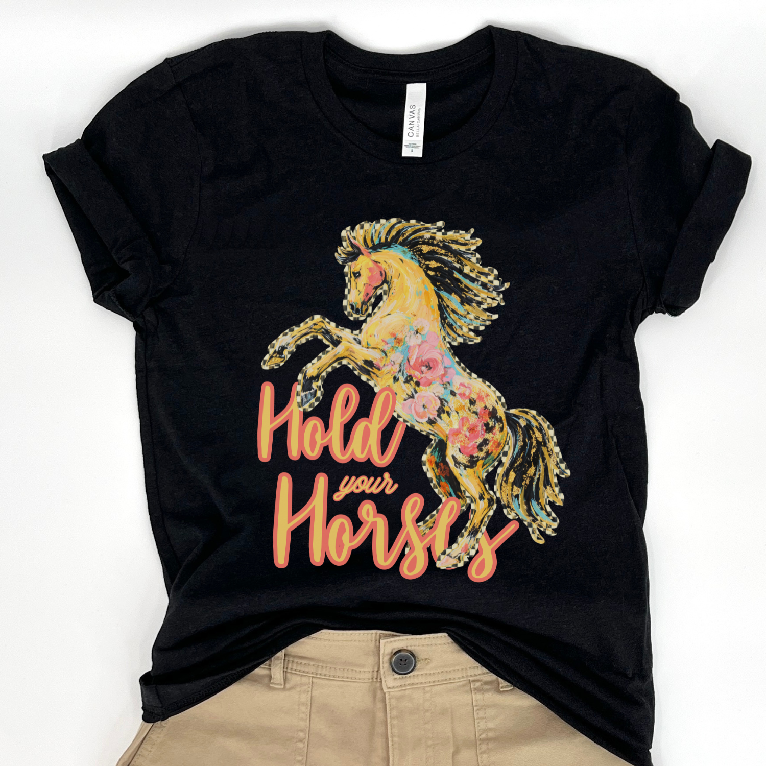 Black t-shirt with a floral horse graphic and 'Hold your Horse' text on a white background.