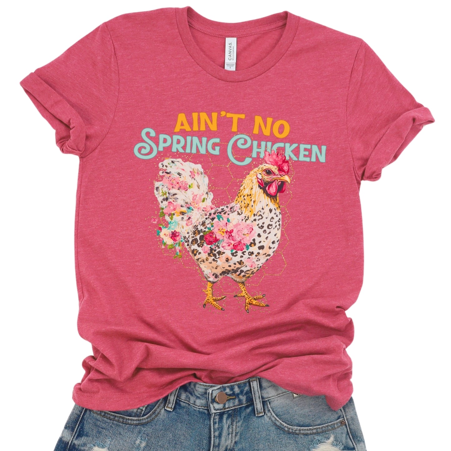 Red t-shirt with a floral chicken graphic and text 'Ain't No Spring Chicken' on a white background.