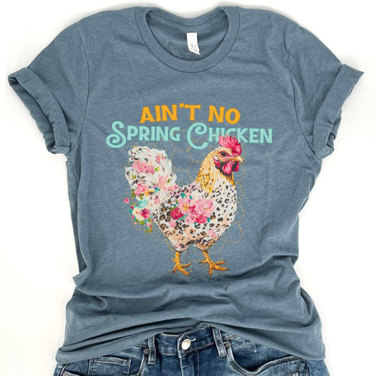 Blue t-shirt with a floral chicken graphic and text on a white background