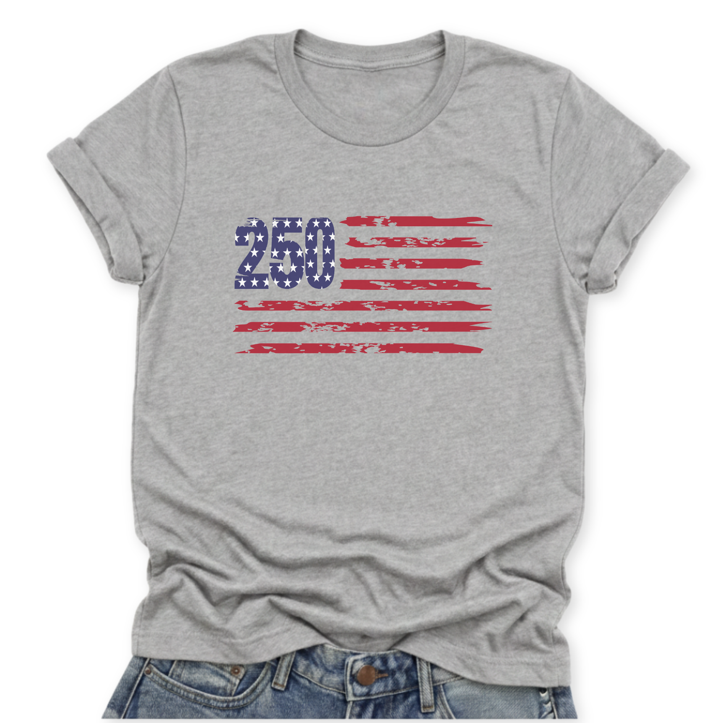 Athletic Heather Gray Bella Canvas t-shirt mockup with rolled sleeves and a front tuck into distressed denim, featuring a small “250” with stars and distressed red flag stripes graphic across the chest.