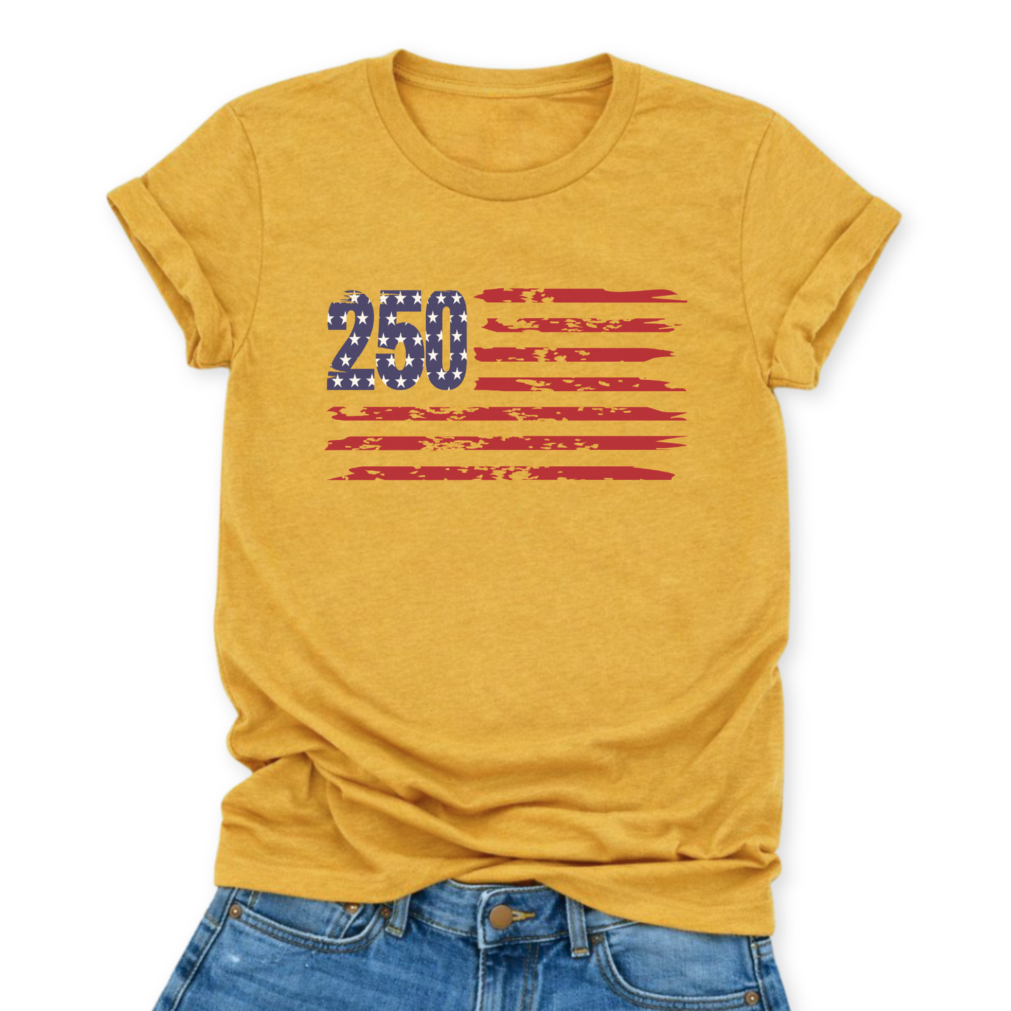 Heather Mustard Bella Canvas t-shirt mockup with rolled sleeves and a front tuck into distressed denim, featuring a small “250” with stars and distressed red flag stripes graphic across the chest.